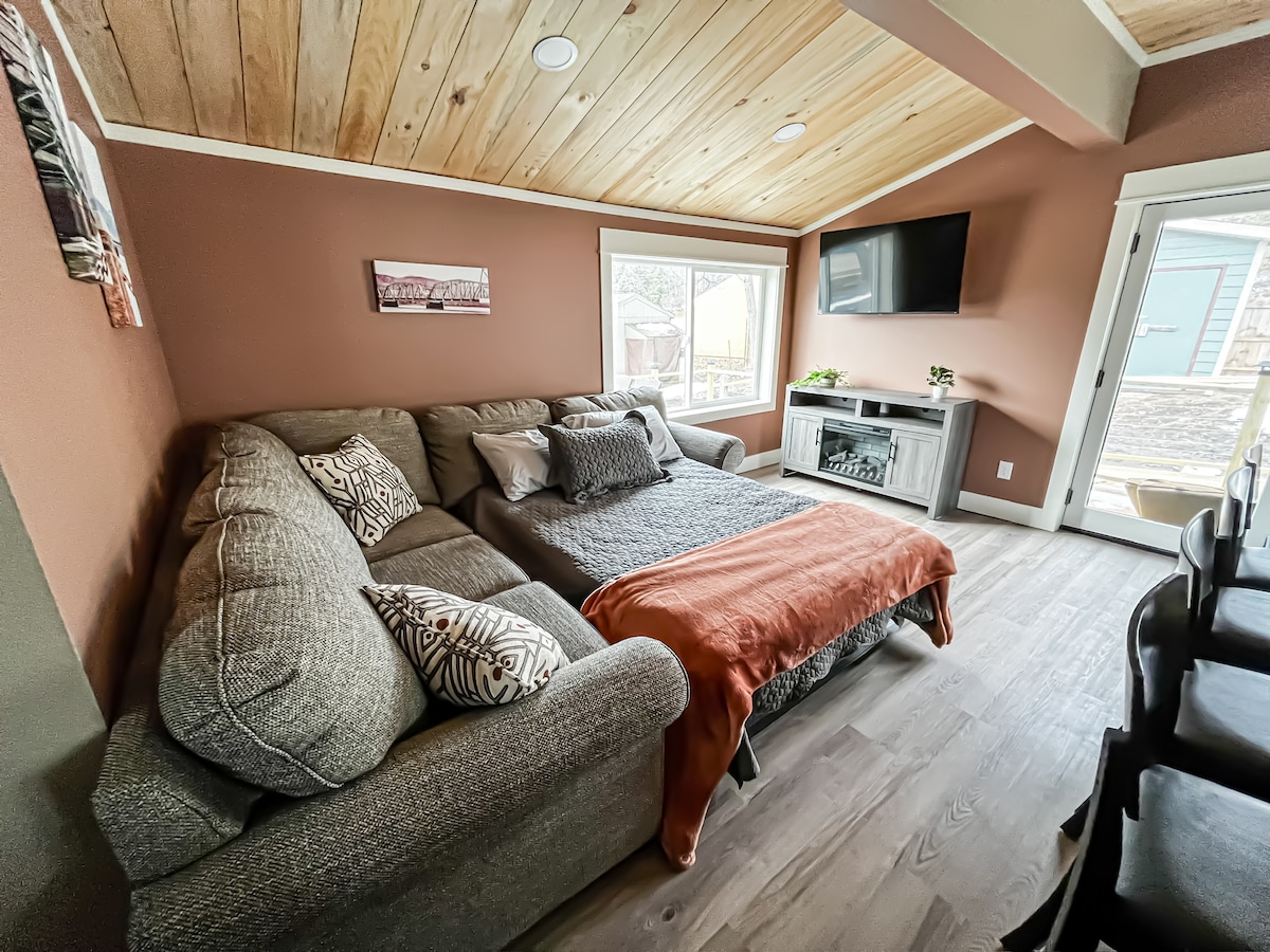 The Hidden Gem — Main Level Living Room (full size sofa bed) with TV with Amazon Firestick and electric fireplace.