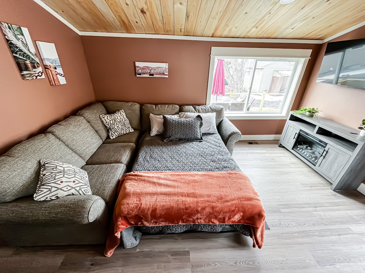 The Hidden Gem — Main Level Living Room (full size sofa bed) with TV and electric fireplace.
